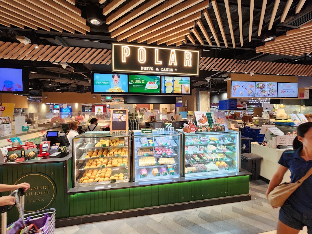 A vibrant display of pastries and cakes at Polar Puffs & Cakes, showcasing a variety of freshly baked goods.