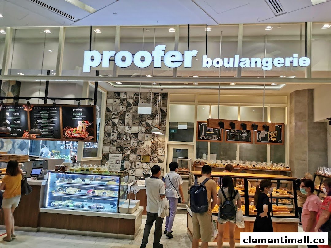 The vibrant storefront of Proofer Boulangerie, showcasing its bakery and pizza offerings with customers browsing.