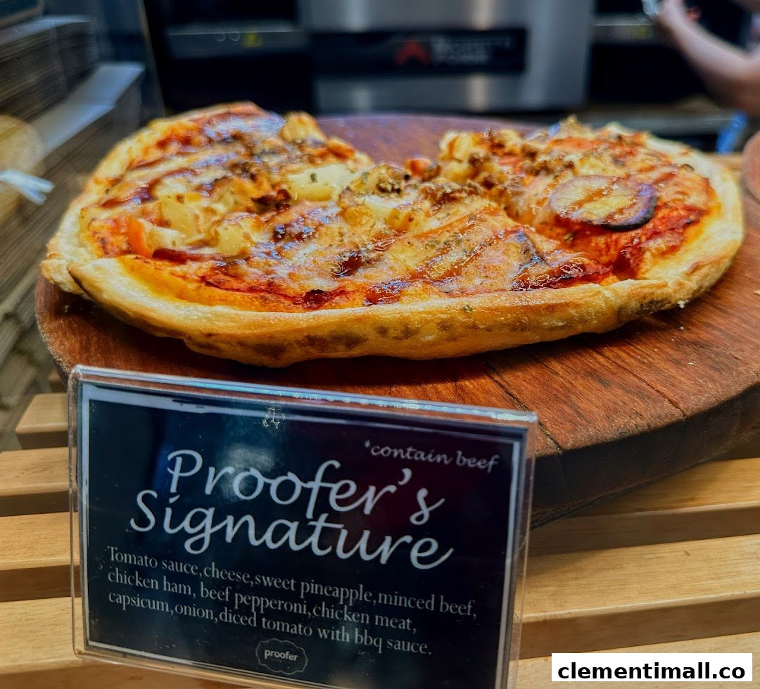A Proofer's Signature pizza with various toppings displayed on a wooden board with its description.