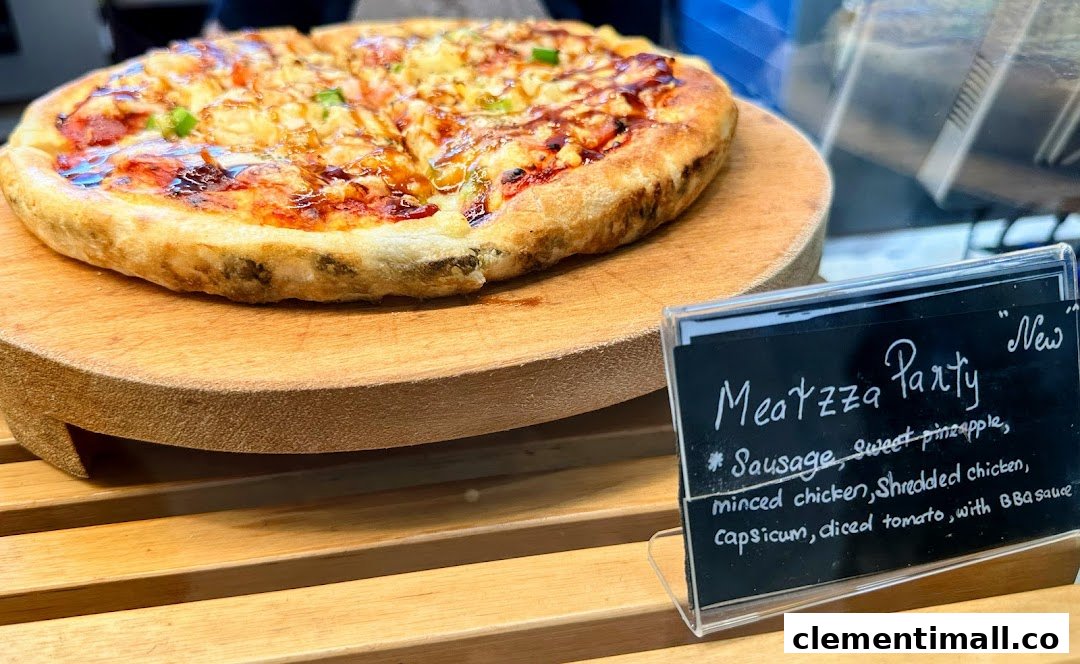A close-up of a 'Meatzza Party' pizza on a wooden stand with its descriptive label.