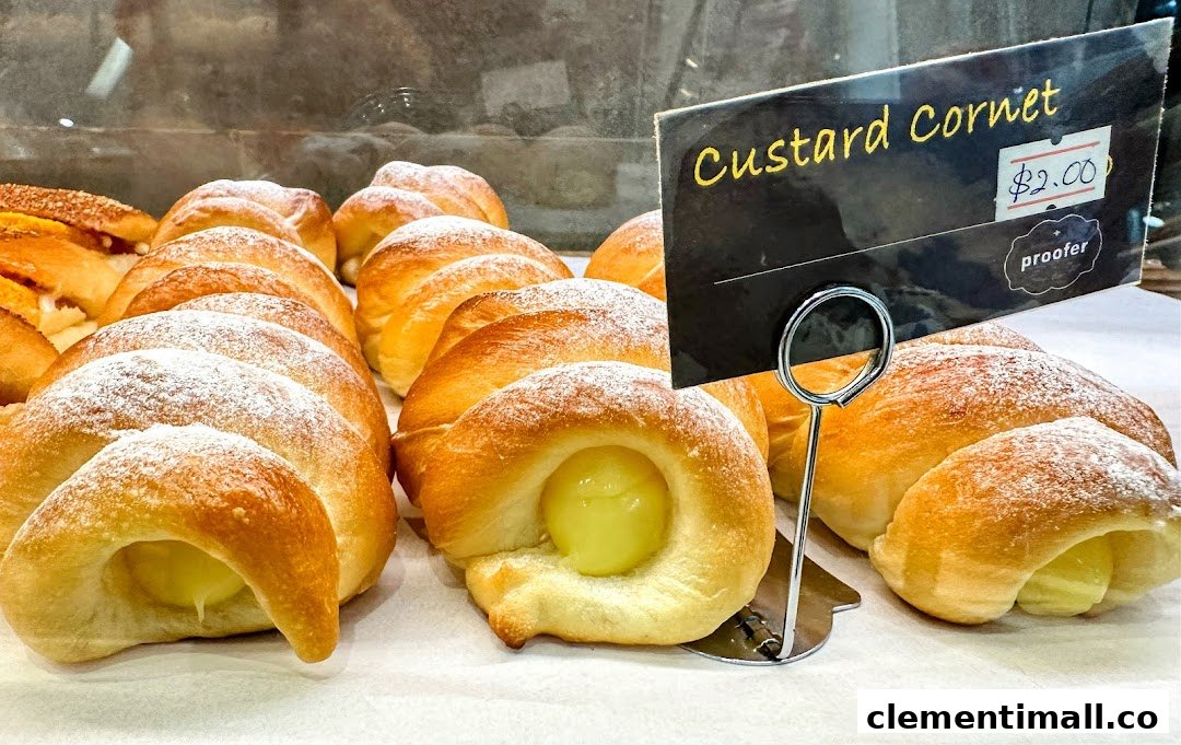 A display of freshly baked Custard Cornets, dusted with powdered sugar, at Proofer Boulangerie.