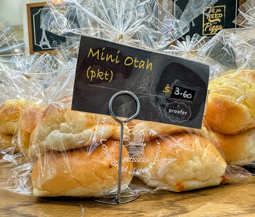Close-up of packaged Mini Otah bread rolls with a price tag at Proofer Boulangerie.