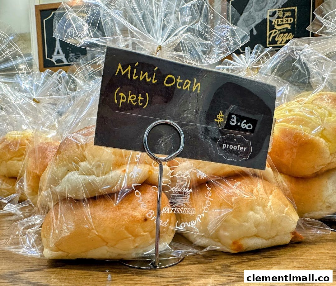 Close-up of packaged Mini Otah bread rolls with a price tag at Proofer Boulangerie.