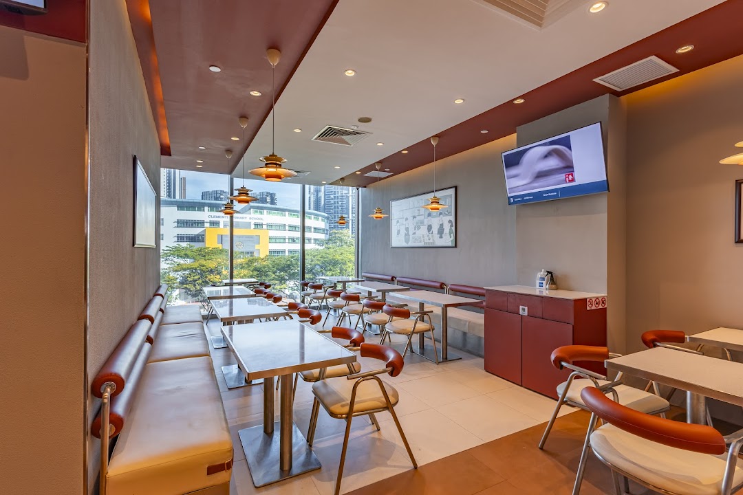 Bright and spacious interior of Qin Ji Rougamo with ample seating, large windows, and modern decor.
