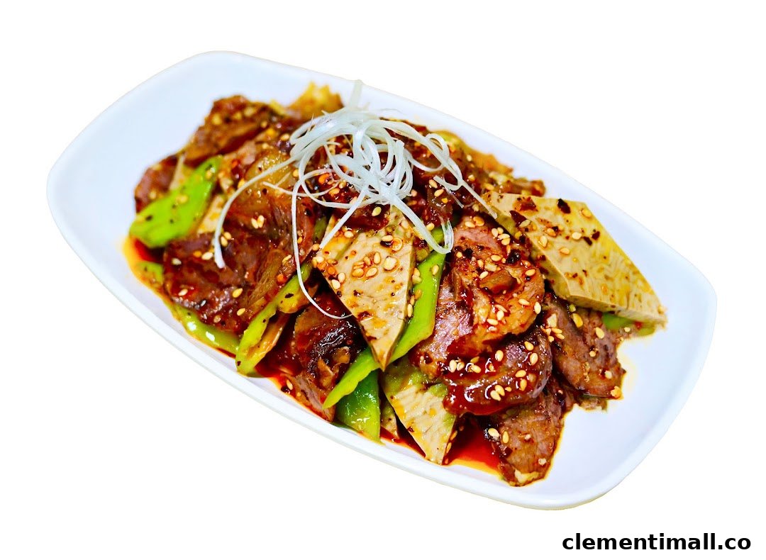 A savory dish featuring sliced meat, green peppers, and other ingredients, garnished with sesame seeds and scallions.