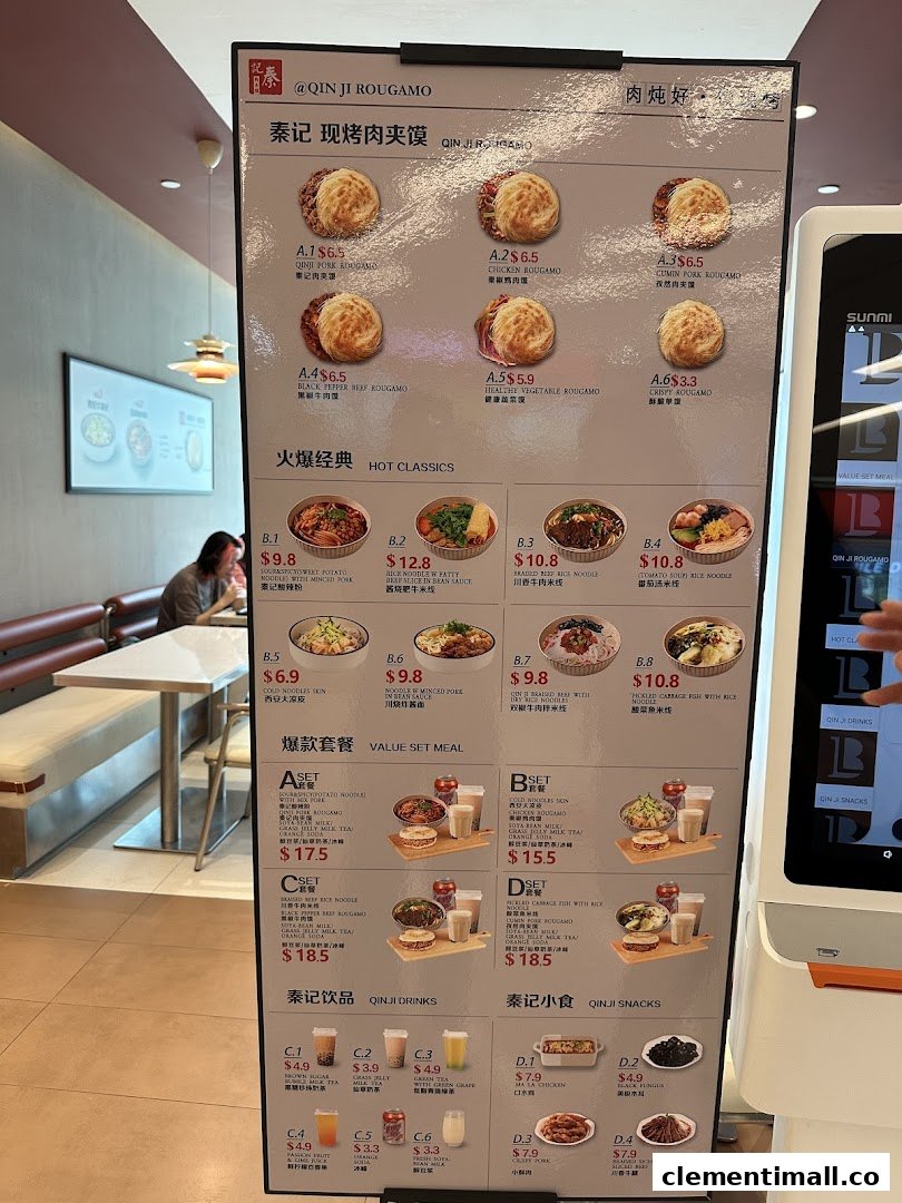 A large digital menu board at Qin Ji Rougamo displaying various rougamou, classic dishes, set meals, and drinks.