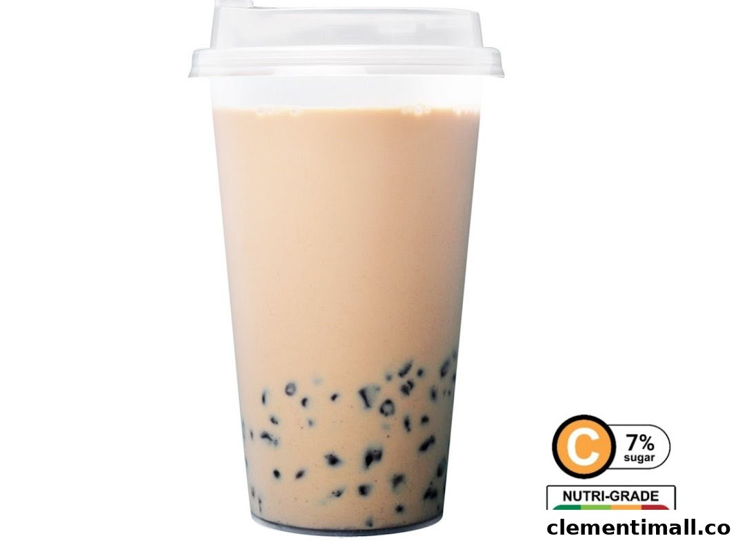 A clear plastic cup of bubble tea with tapioca pearls and a Nutri-Grade C label indicating 7% sugar.