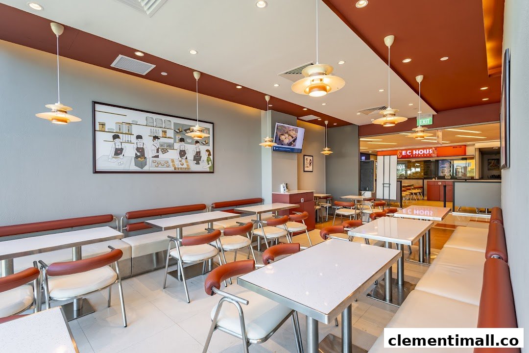 A bright and inviting interior view of Qin Ji Rougamo restaurant with comfortable seating and a unique wall mural.