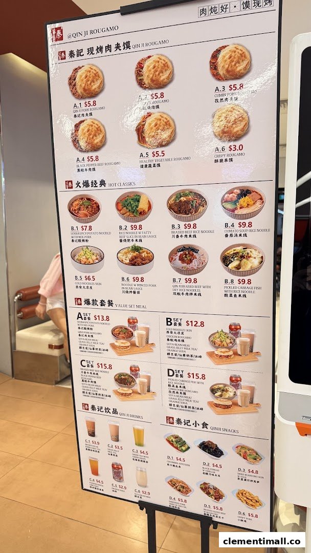 A detailed menu board for Qin Ji Rougamo, showcasing various rougamou, classic dishes, set meals, drinks, and snacks.