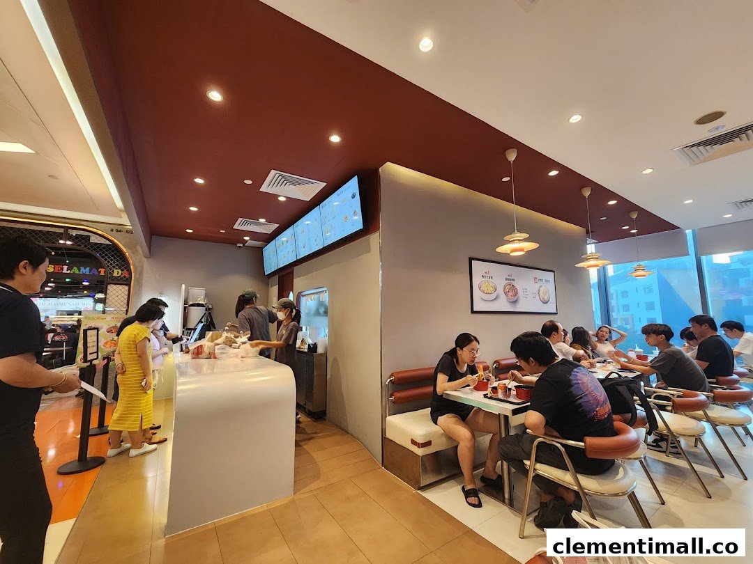 Customers dine and order at Qin Ji Rougamo, showcasing a bustling interior with modern decor.