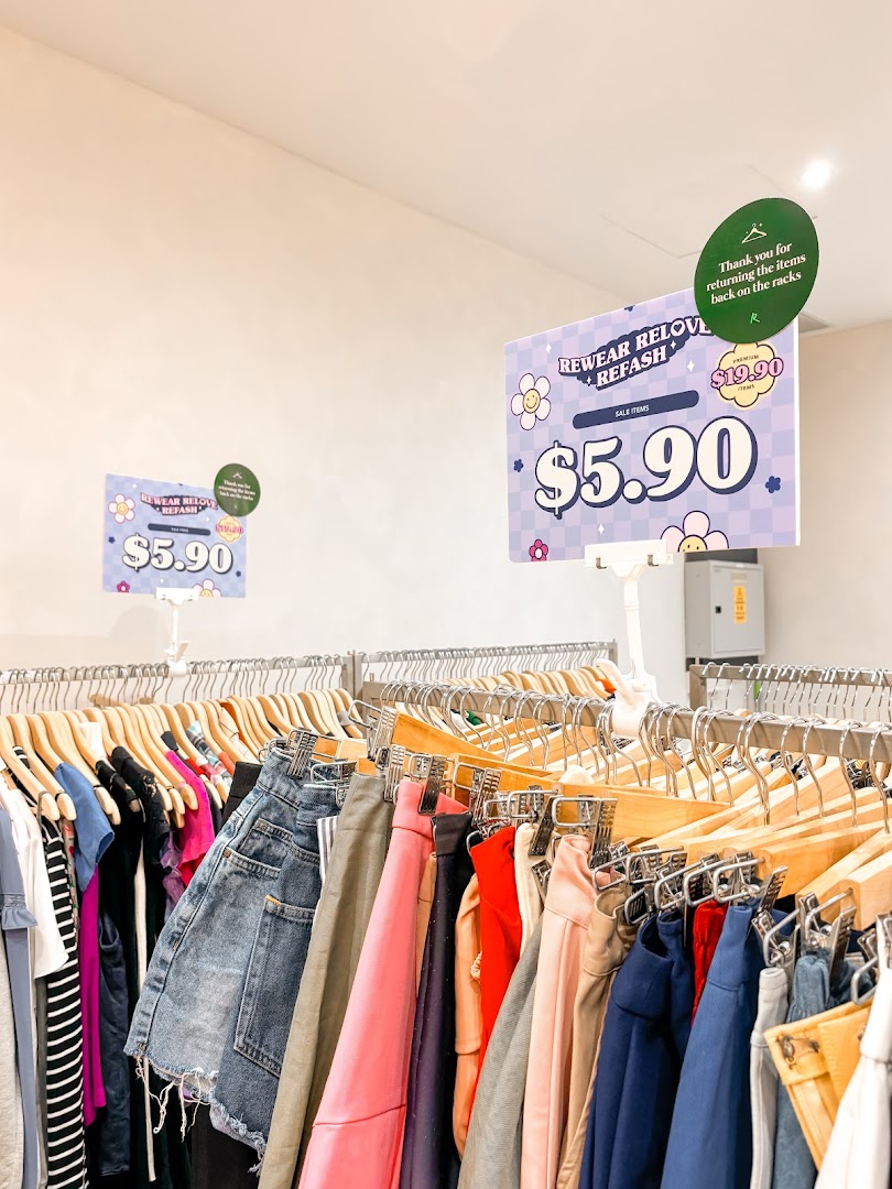Racks of pre-loved clothing with sale signs indicating items priced at $5.90.