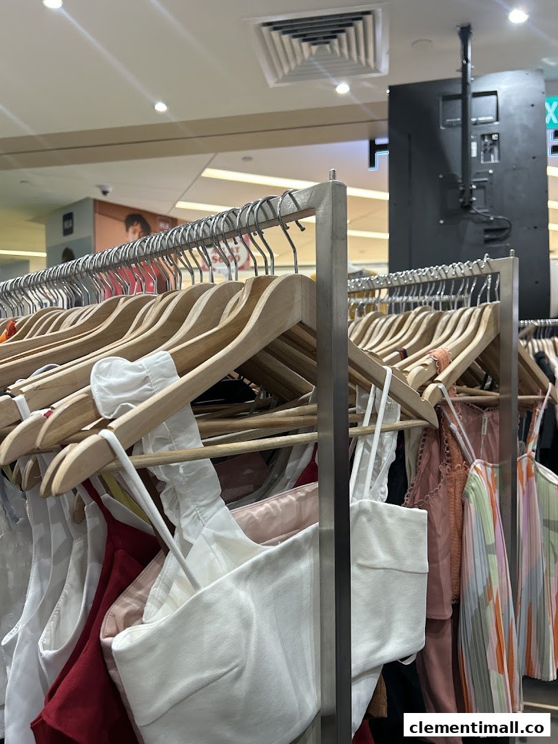 A close-up view of various pre-loved fashion items displayed on hangers inside REFASH.