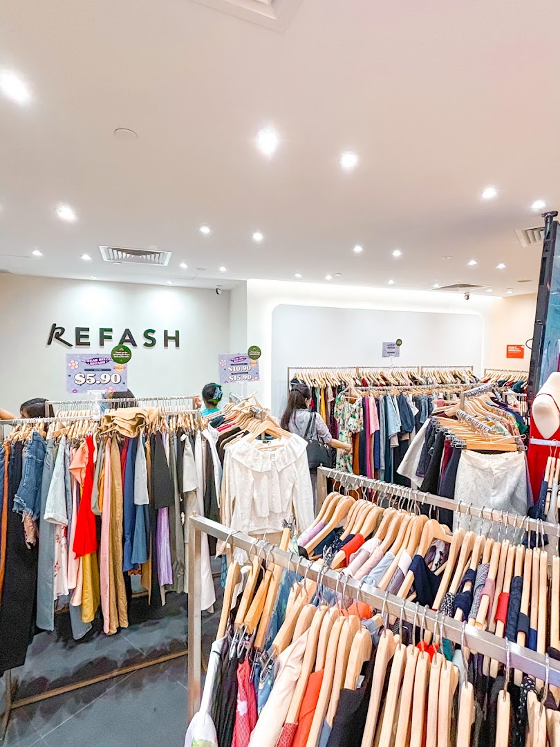 Interior view of REFASH, showcasing numerous racks of pre-loved clothing for sale.