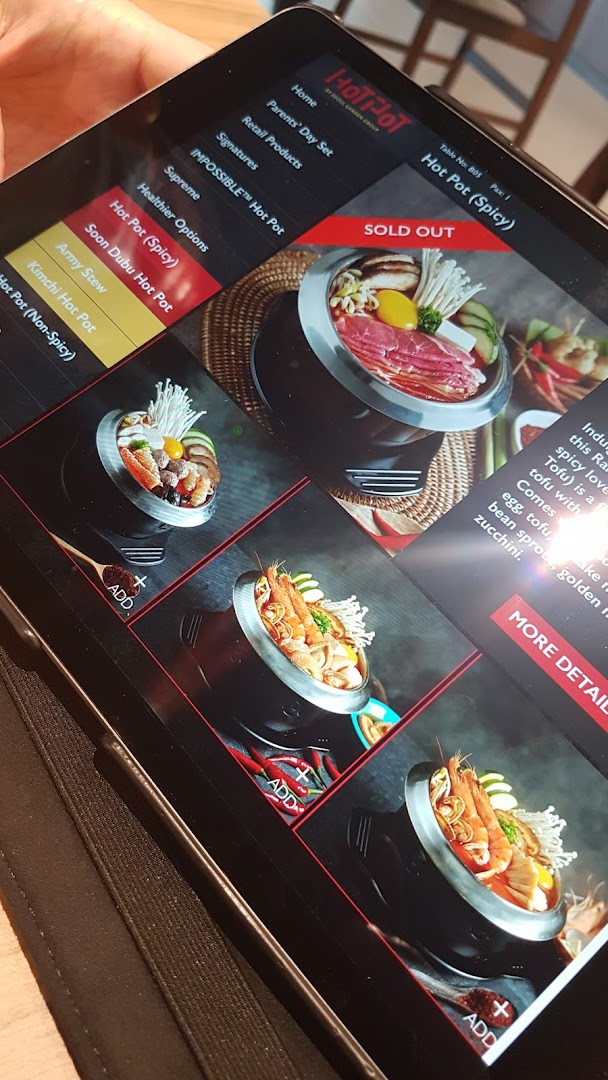 A digital menu displayed on a tablet, showcasing various hot pot options with images and descriptions.