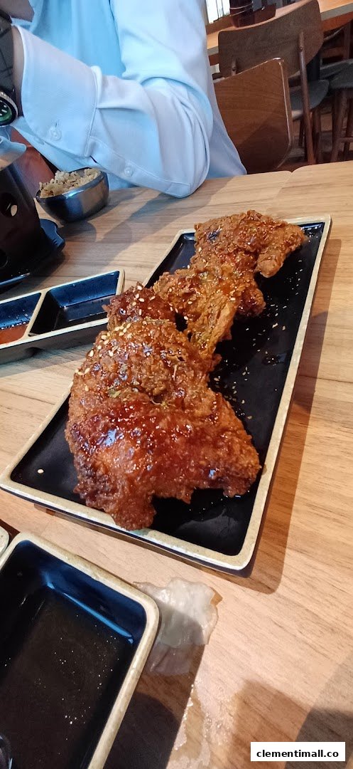 A plate of crispy, glazed fried chicken served on a black rectangular dish at Seoul Garden.