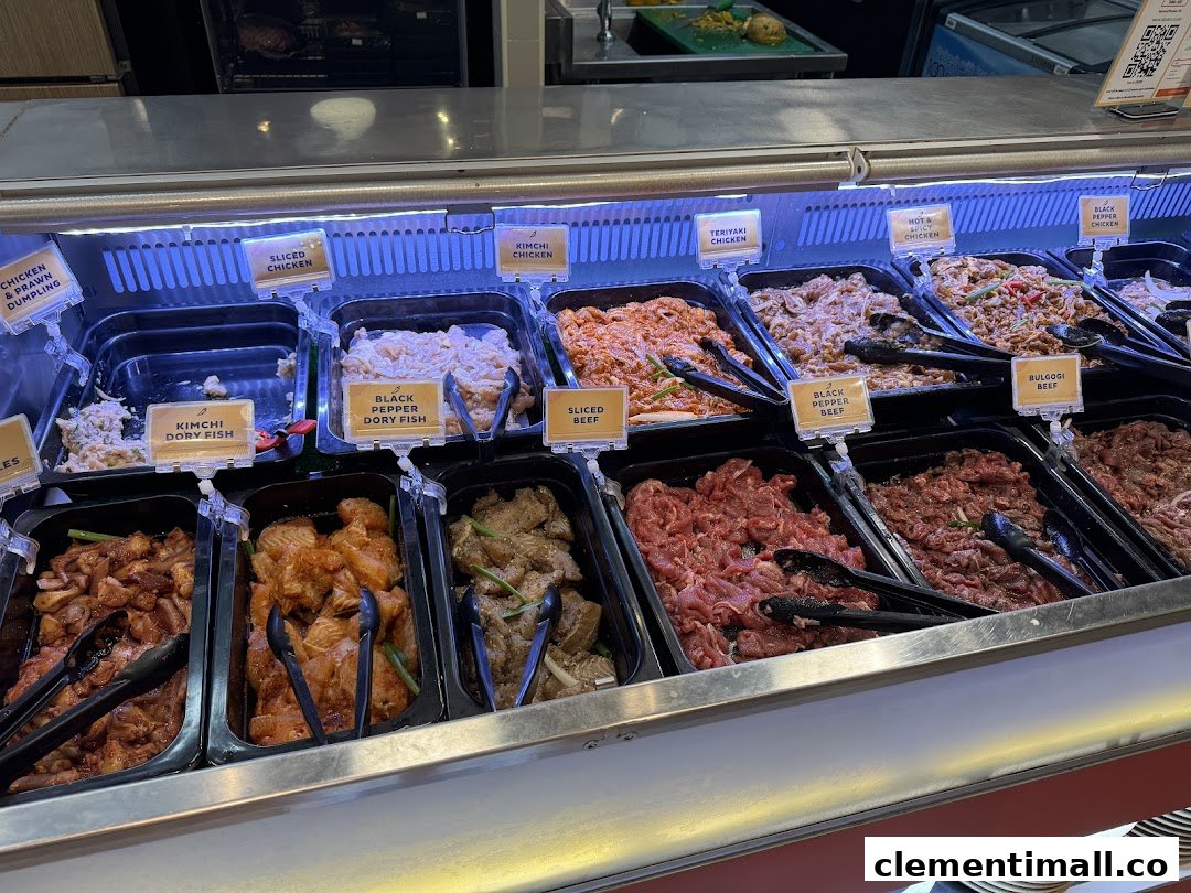 A vibrant display of various marinated meats and seafood in a buffet-style counter at Seoul Garden.
