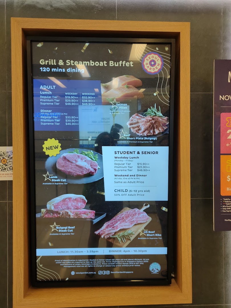 A digital menu board displaying prices and food options for a Grill & Steamboat Buffet at Seoul Garden.