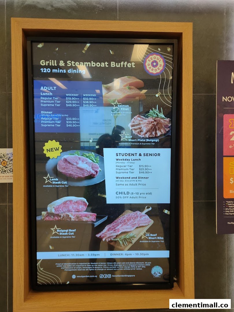 A digital menu board displaying prices and food options for a Grill & Steamboat Buffet at Seoul Garden.