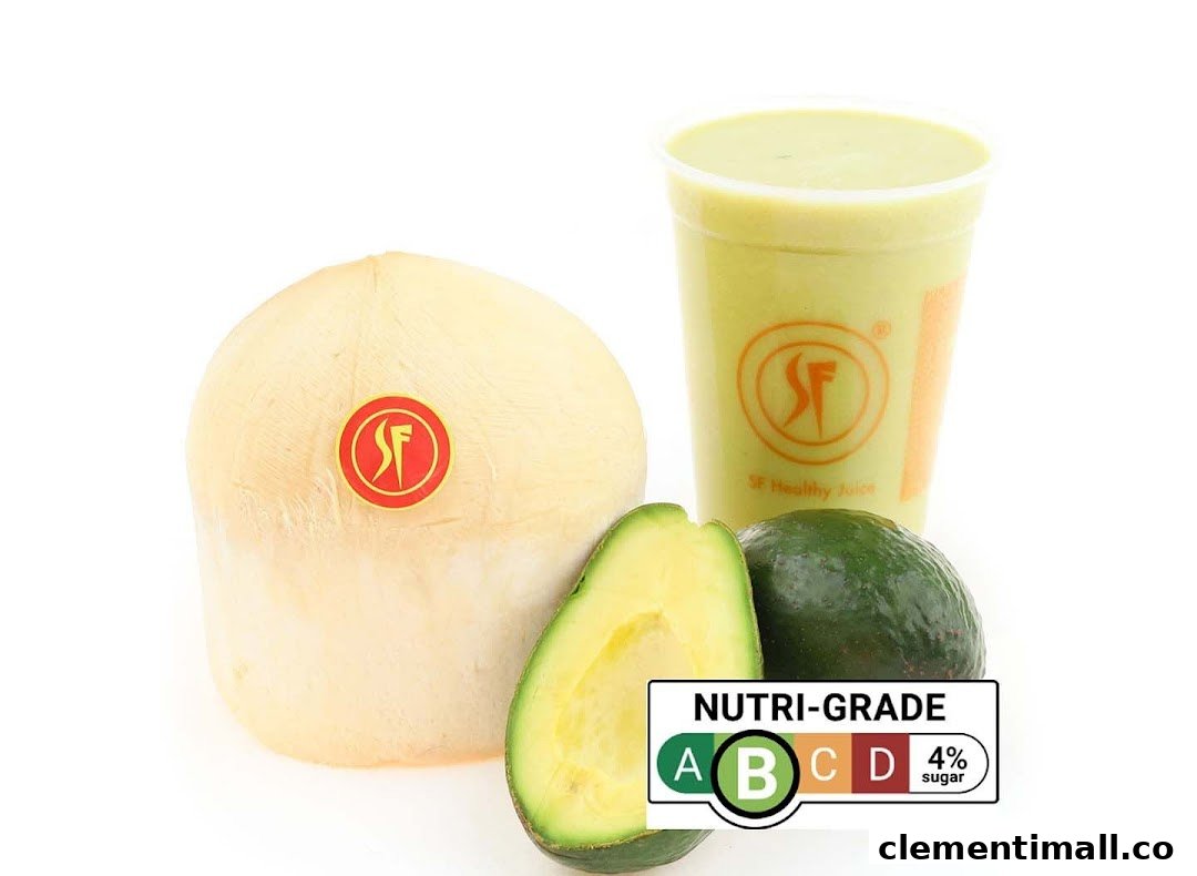 A fresh coconut, whole and sliced avocados, and a green smoothie with a nutri-grade label.