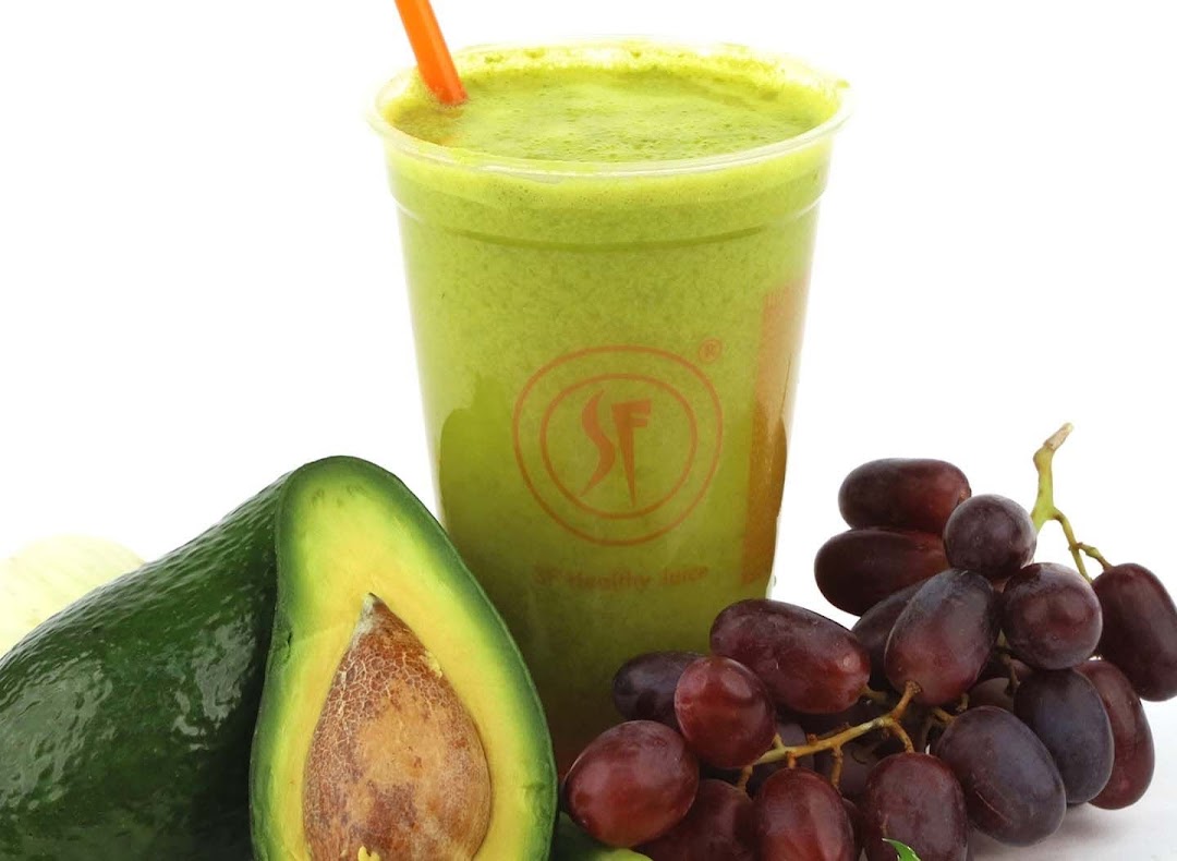 A vibrant green juice with fresh avocado and grapes, showcasing healthy beverage options.