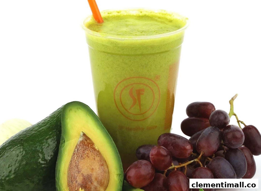 A vibrant green juice with fresh avocado and grapes, showcasing healthy beverage options.