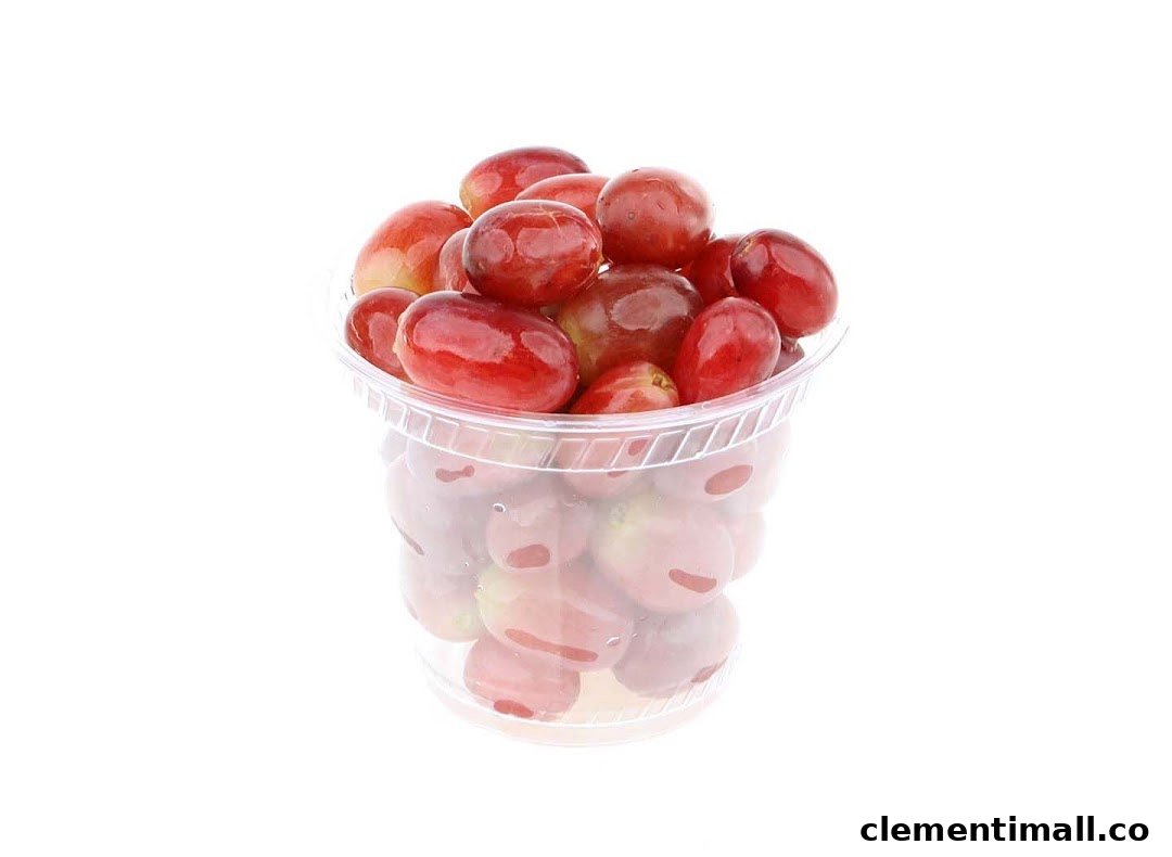 A clear plastic cup filled with vibrant red grapes, ready for a healthy snack.