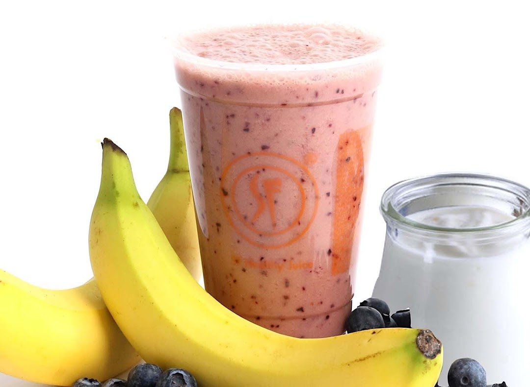 A vibrant smoothie with bananas, blueberries, and yogurt, showcasing fresh ingredients.