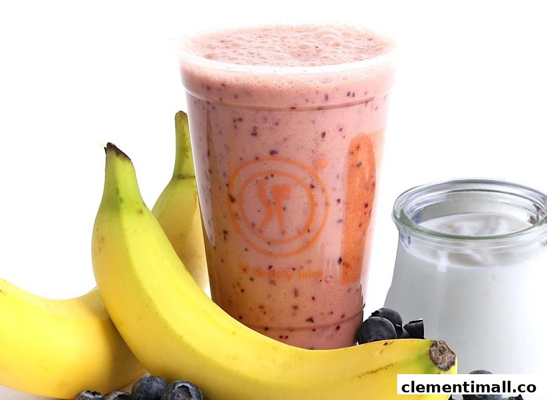 A vibrant smoothie with bananas, blueberries, and yogurt, showcasing fresh ingredients.