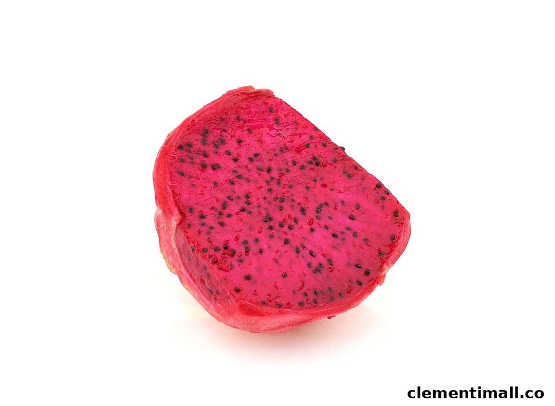 A vibrant red dragon fruit slice with black seeds on a white background.