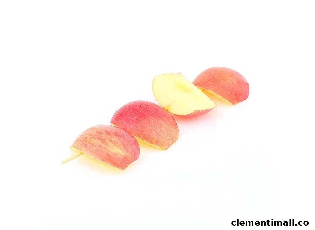 Red apple slices on a stick, presented against a clean white background.