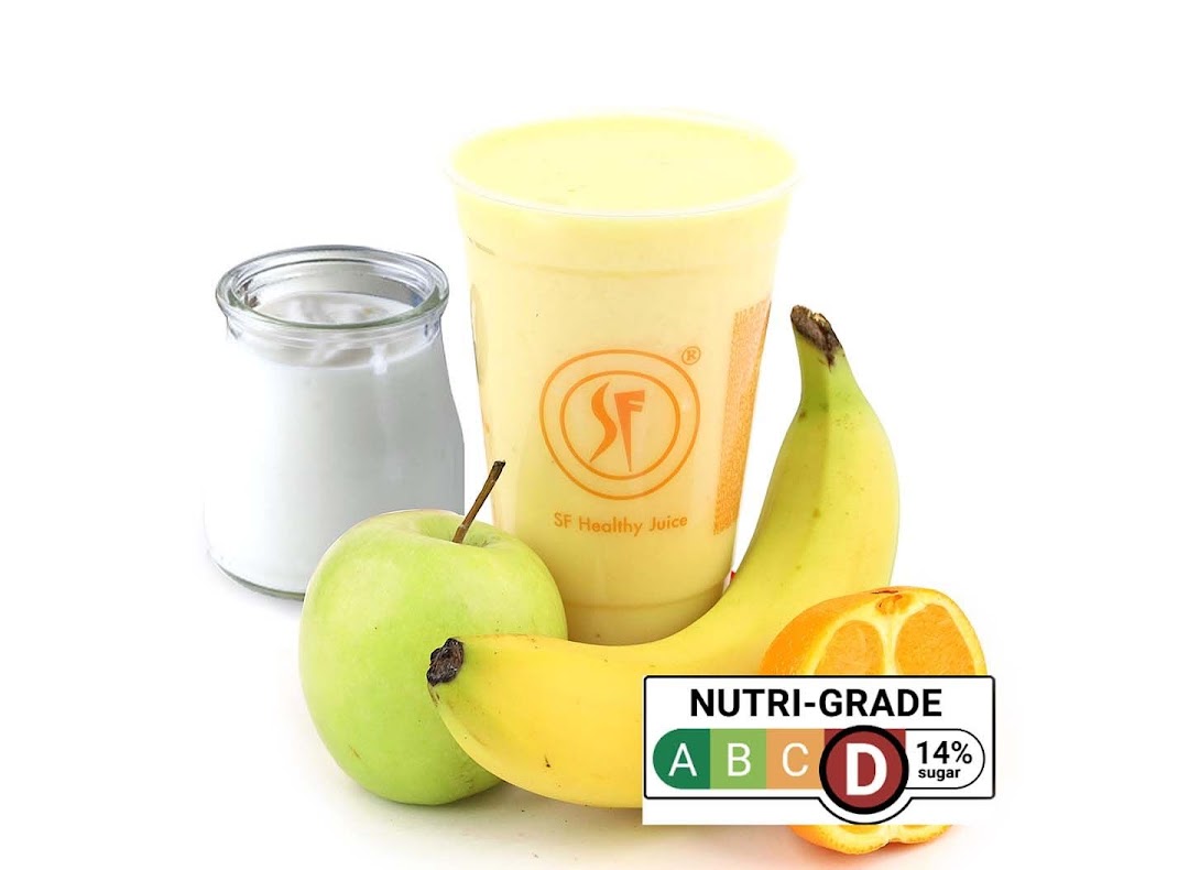 A vibrant fruit smoothie with fresh apple, banana, and orange, featuring a Nutri-Grade D label.