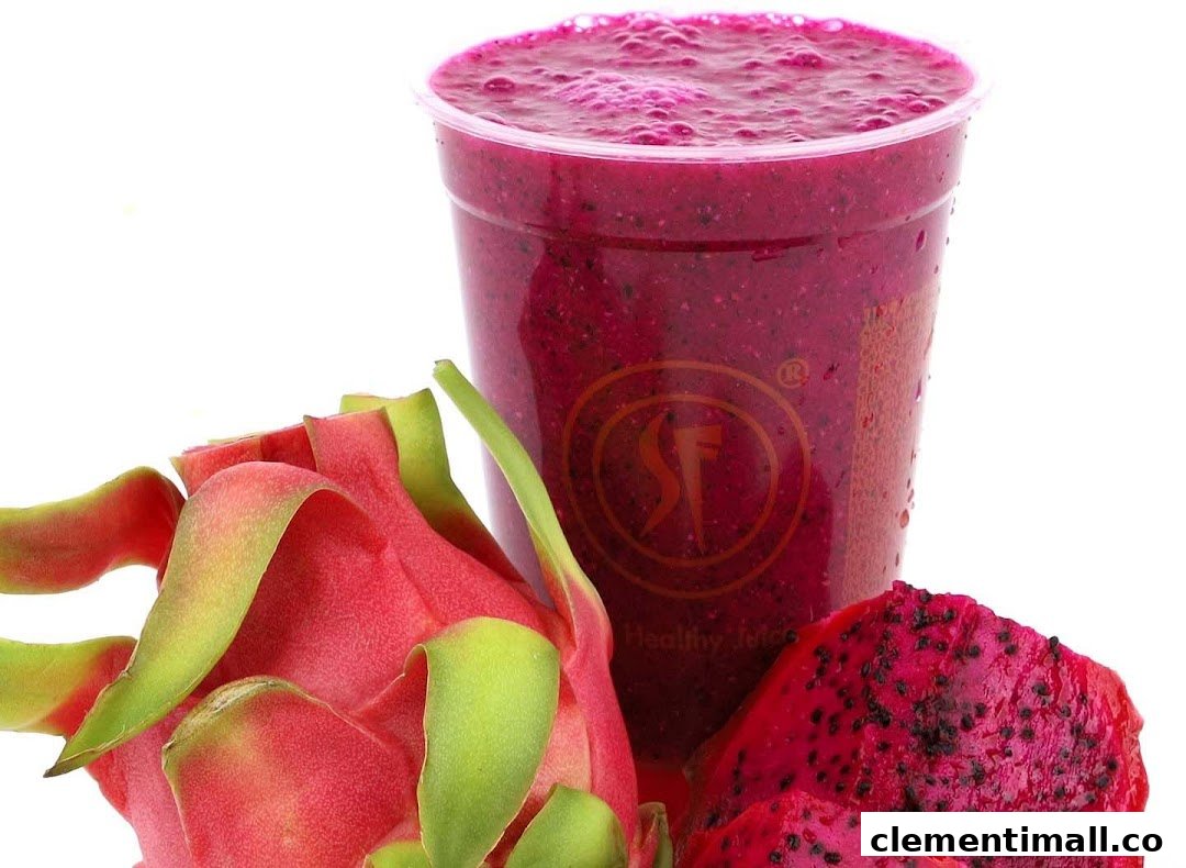 A vibrant dragon fruit smoothie in a cup, accompanied by fresh dragon fruit.
