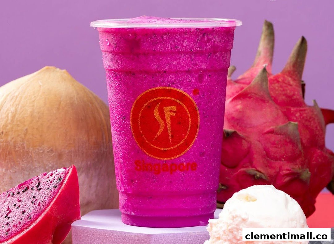 A vibrant pink dragon fruit smoothie with fresh dragon fruit and coconut in the background.