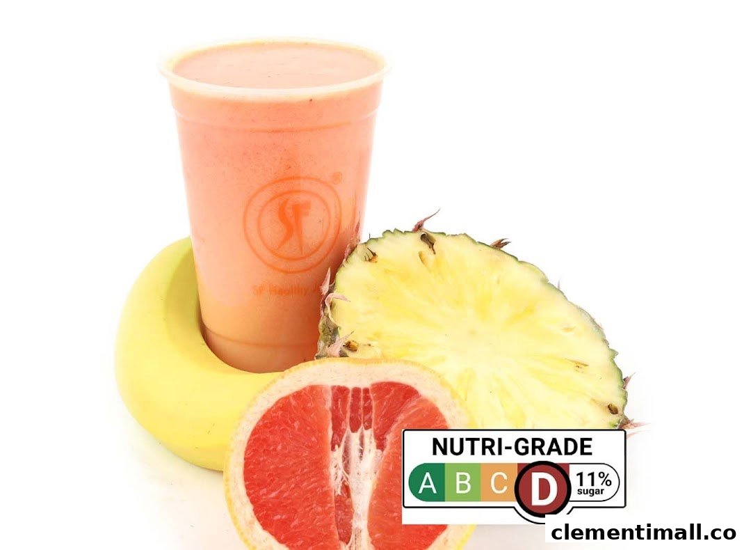 A vibrant fruit smoothie with fresh banana, pineapple, and grapefruit, featuring a Nutri-Grade label.