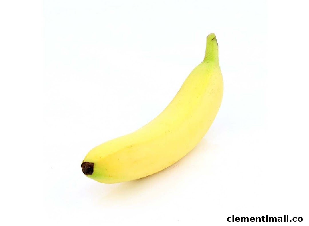 A single ripe yellow banana is displayed against a clean white background.