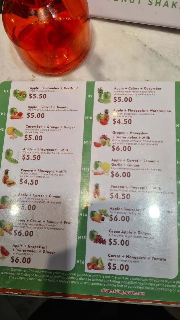 A detailed menu board displaying various fruit and vegetable juice blends with their prices and health benefits.
