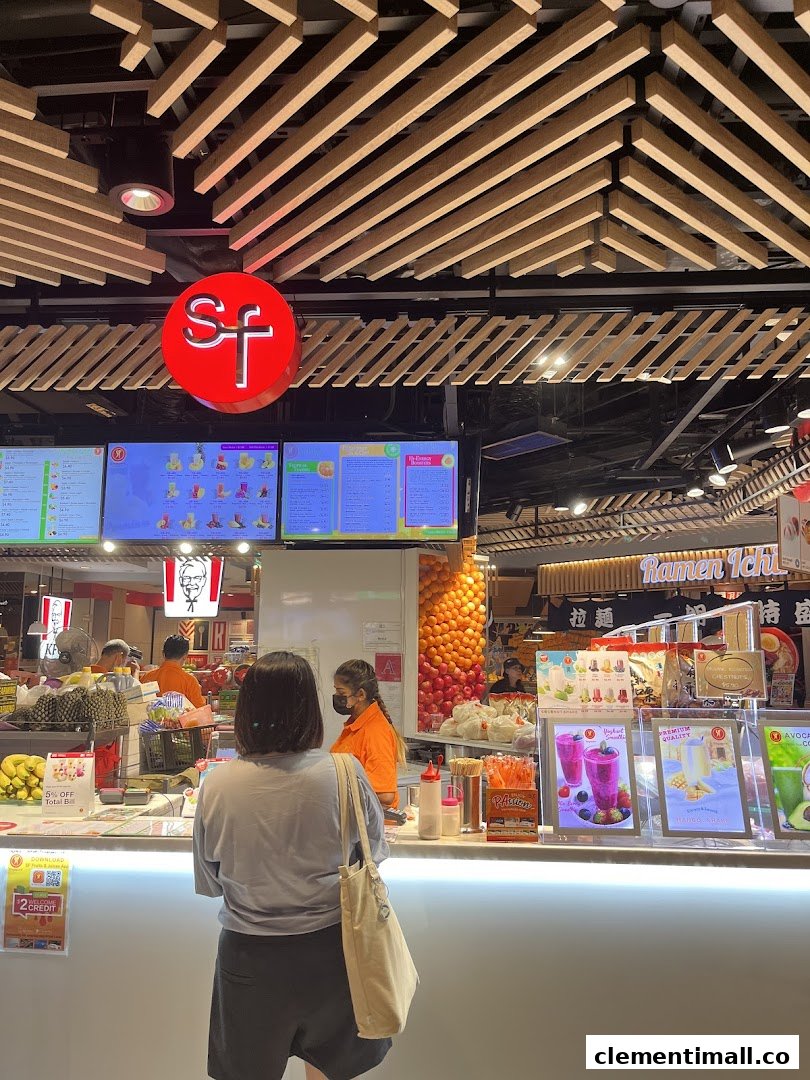 Digital menus display a wide array of fresh fruit juices and smoothies at SF Fruits & Juices.