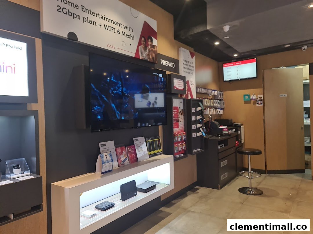 Interior view of a Singtel shop showcasing mobile devices, home entertainment plans, and a customer service area.