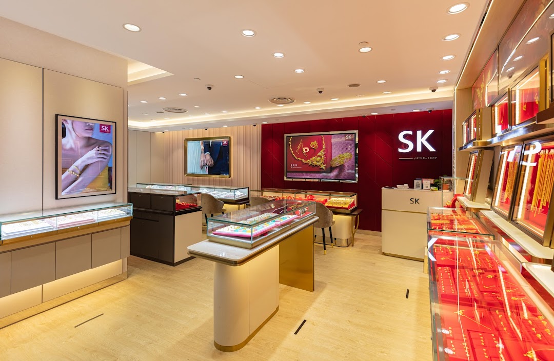 Interior view of SK Jewellery store showcasing elegant display cases and digital screens.