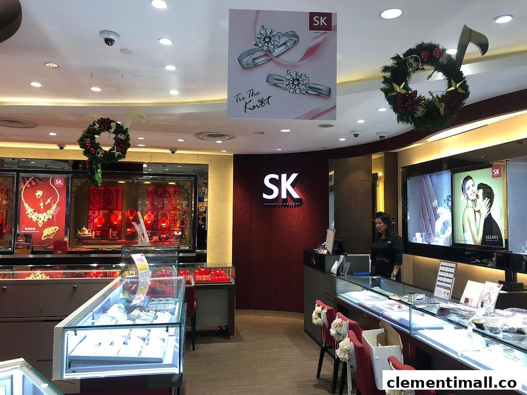 Interior view of SK Jewellery shop showcasing display cases, a service counter, and festive decorations.