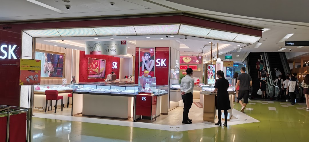 The brightly lit storefront of SK Jewellery, showcasing dazzling displays of fine jewellery and welcoming customers.