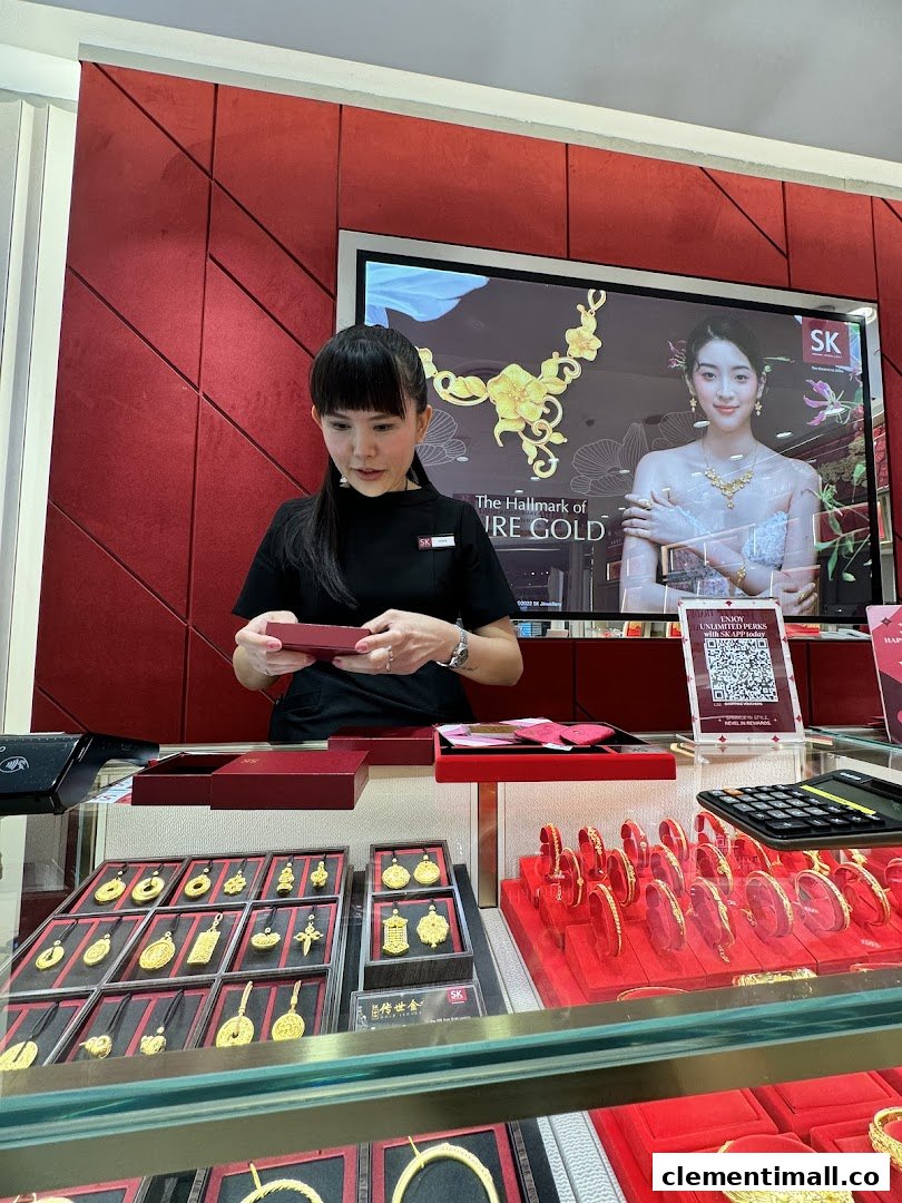 A staff member at SK Jewellery assists a customer amidst displays of exquisite gold jewelry.