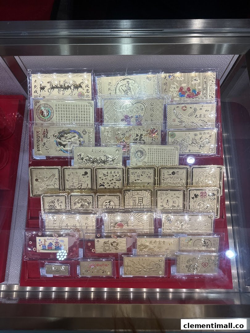 A display case showcasing numerous gold-colored plaques and bars with intricate designs and Chinese characters.