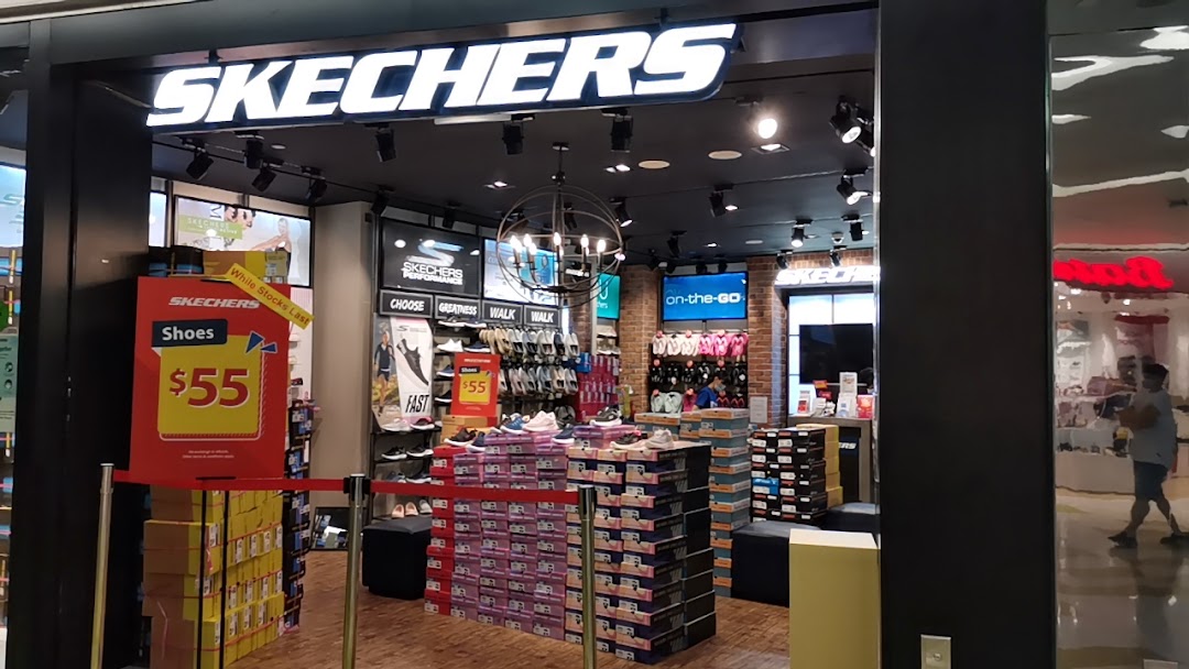 An inviting view inside a Skechers store, showcasing a wide range of footwear and promotional displays.