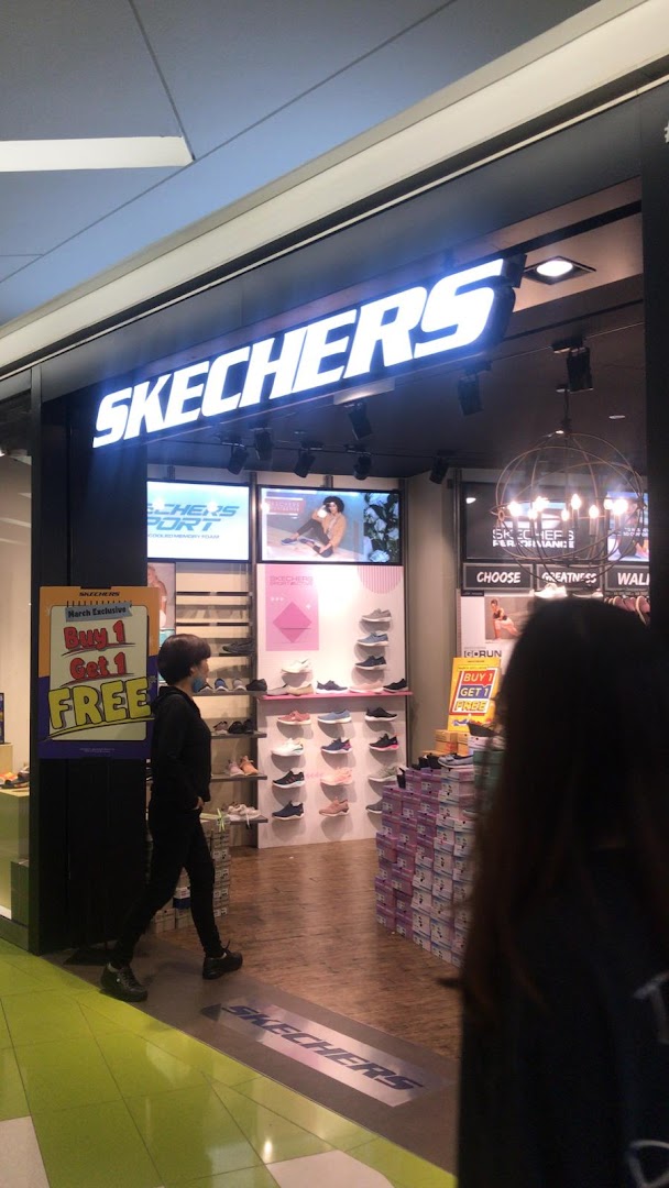 The Skechers store entrance features a bright logo, shoe displays, and a 'Buy 1 Get 1 FREE' promotion.
