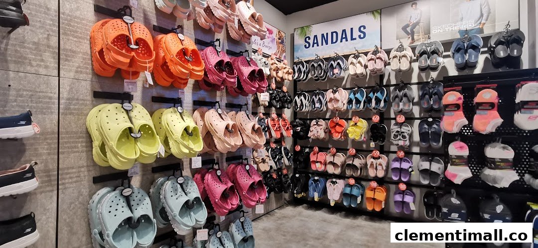 A vibrant display of Skechers sandals, clogs, and socks in various colors inside the store.