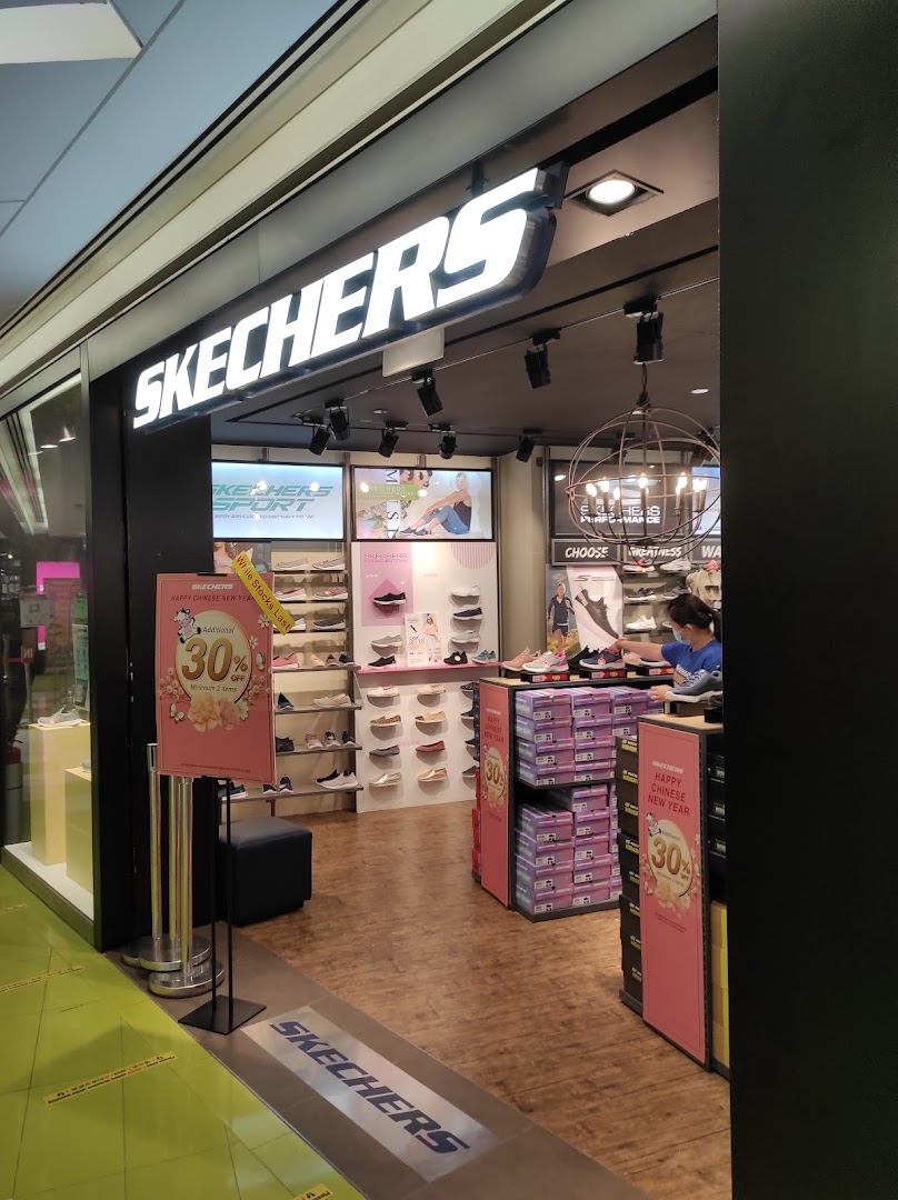 The entrance of a Skechers shoe store with promotional signage and visible shoe displays.