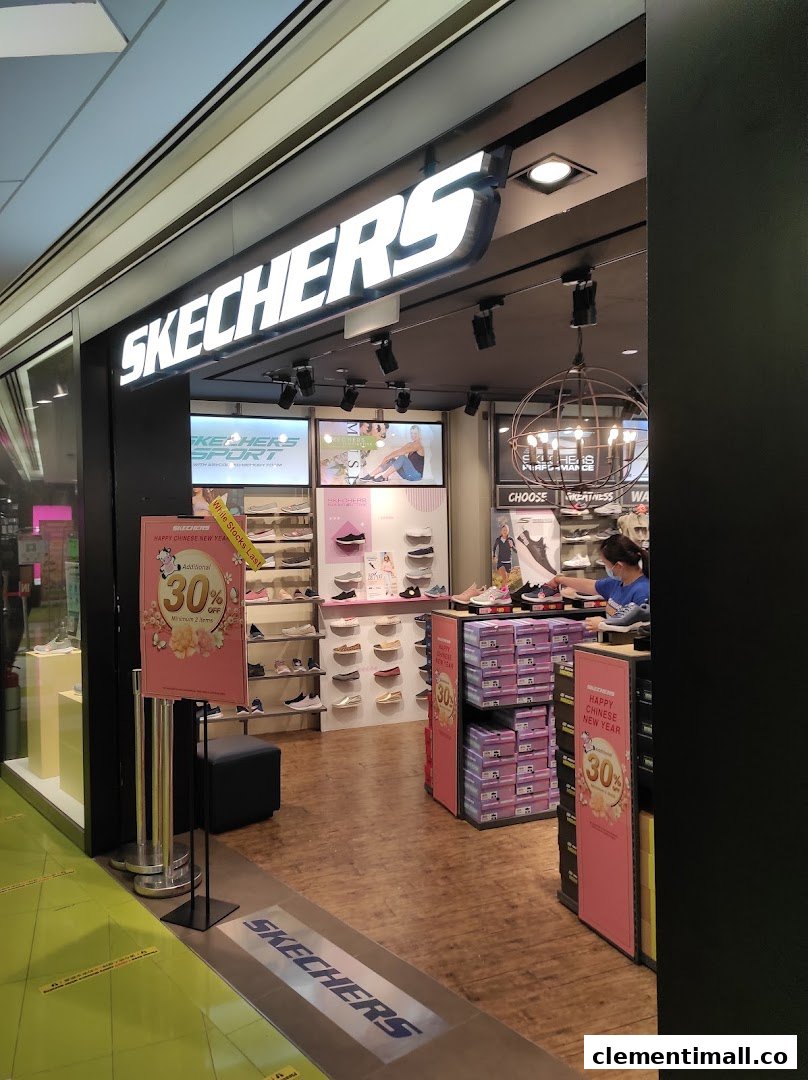 The entrance of a Skechers shoe store with promotional signage and visible shoe displays.