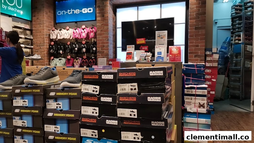 An interior view of a Skechers store showcasing various footwear, shoe boxes, and displays.