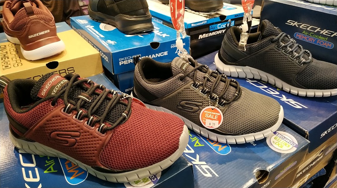 A display of various Skechers athletic and casual shoes, including models with Air-Cooled Memory Foam.